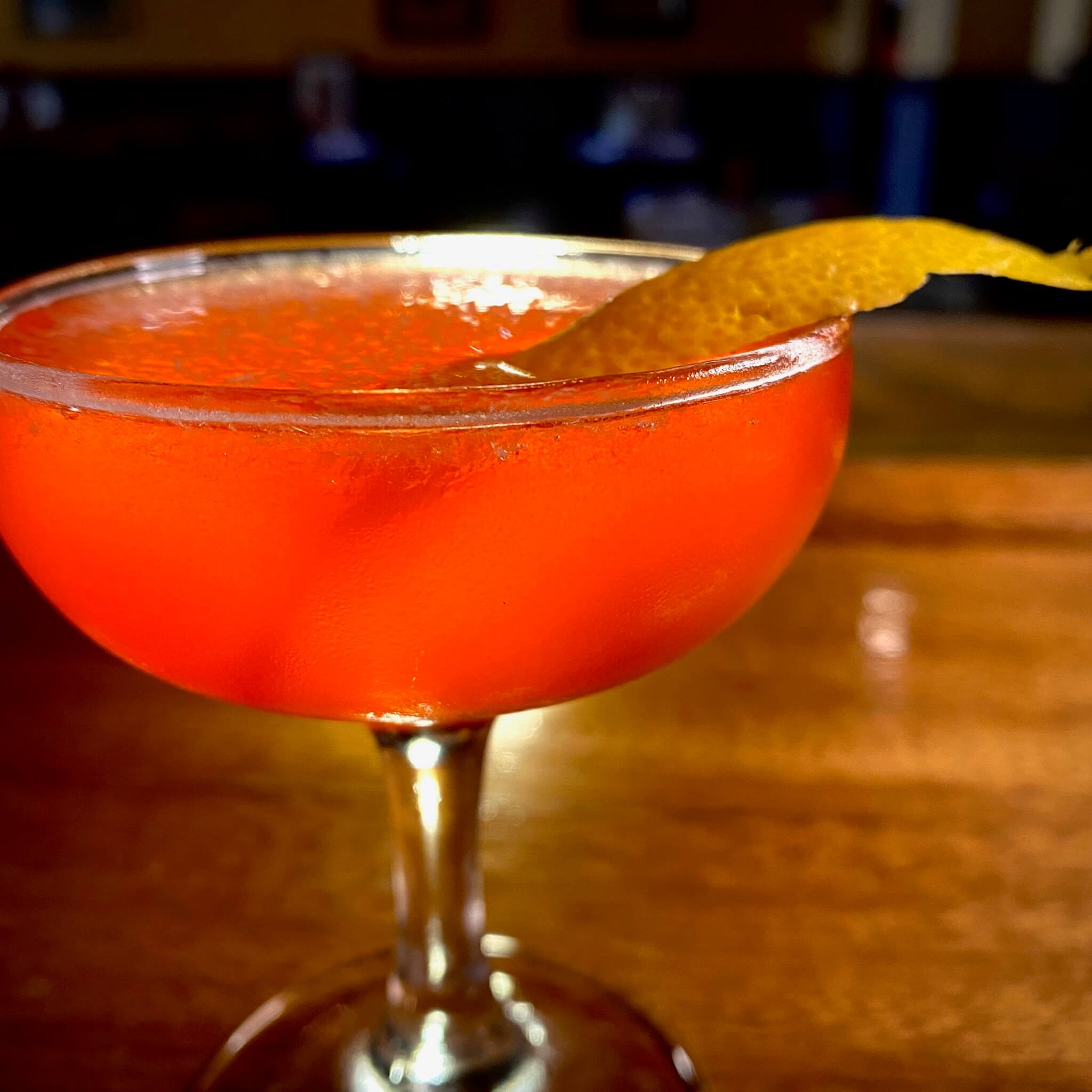 Orange cocktail with a orange peel